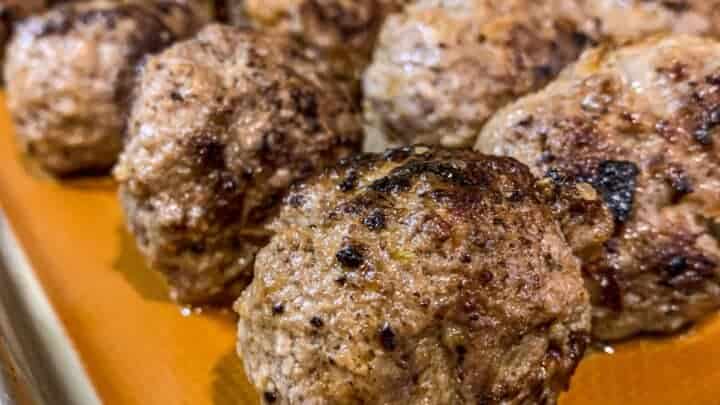 Baked homemade meatballs on a sheet pan